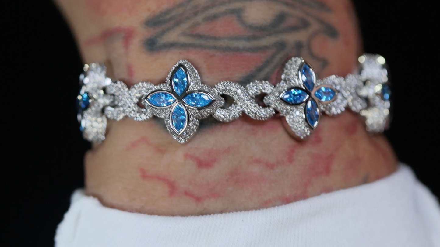 Silver bracelet with blue gemstones on a wrist with tattoos