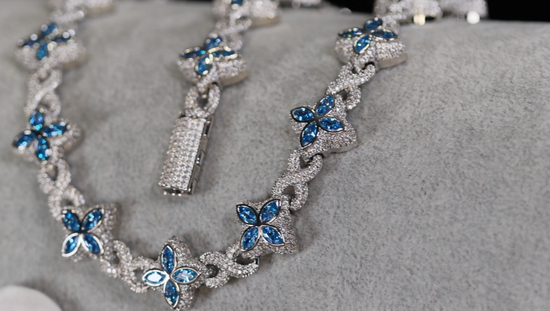 Silver necklace with blue gemstones on a gray surface