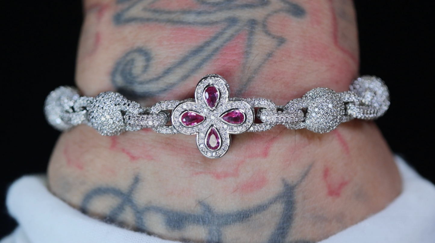 Silver bracelet with red gemstones