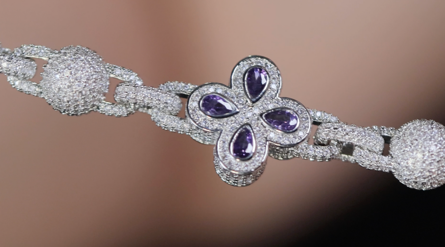 Silver bracelet with purple gemstones